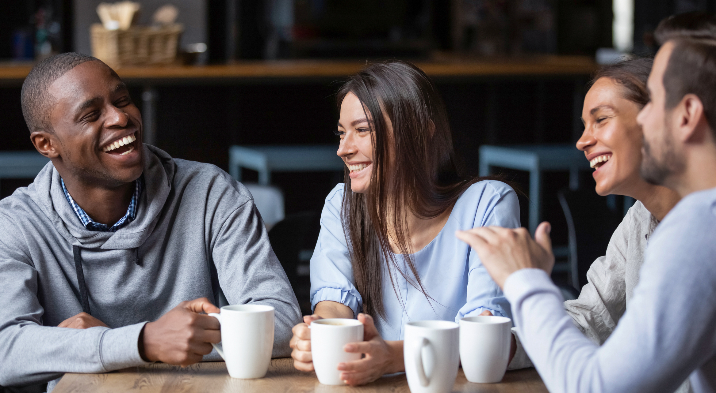 Group of friends talking over a cup of coffee. 